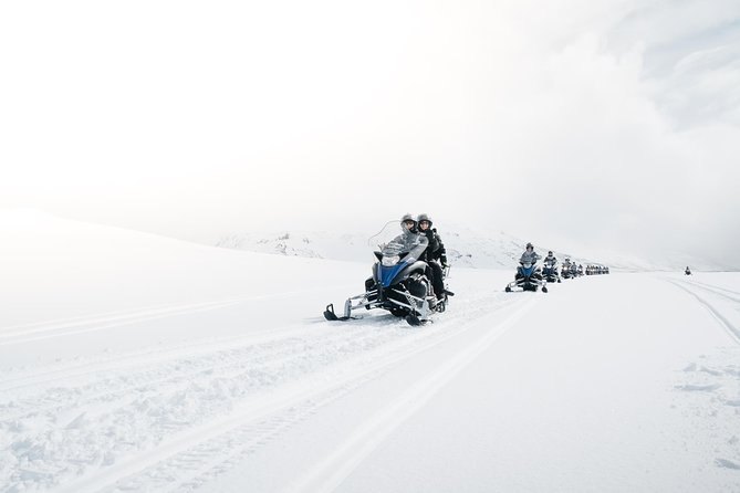 One snowmobile on Langjokull in flat white light with no horizon