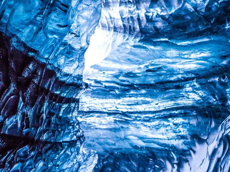 Layered blue ice in the wall of a glacier tunnel