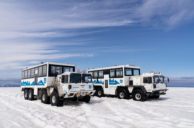 Two eight-wheeled glacier trucks parked out on the Langjokull ice cap